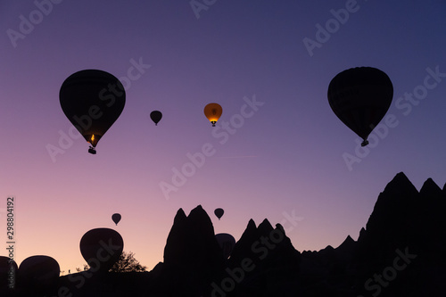 silhouette of hot air balloons in the morning sky over Cappadocia, Turkey