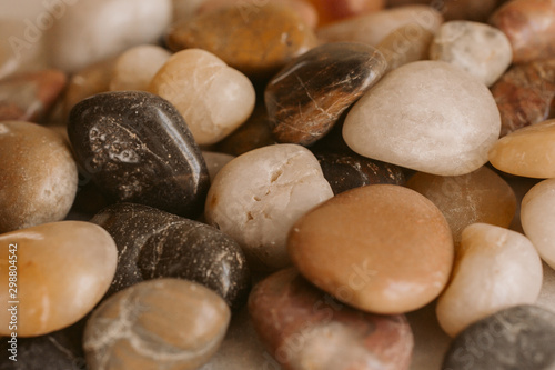 Stones and pebbles as background. Multicolor pebbles at the seaside close up view. 