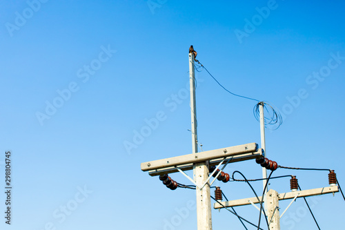 Electrical pole on the blue sky background