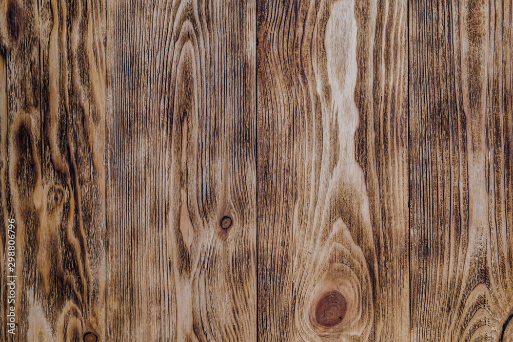 Fototapeta premium Wooden background or texture. Burnt wood with knots