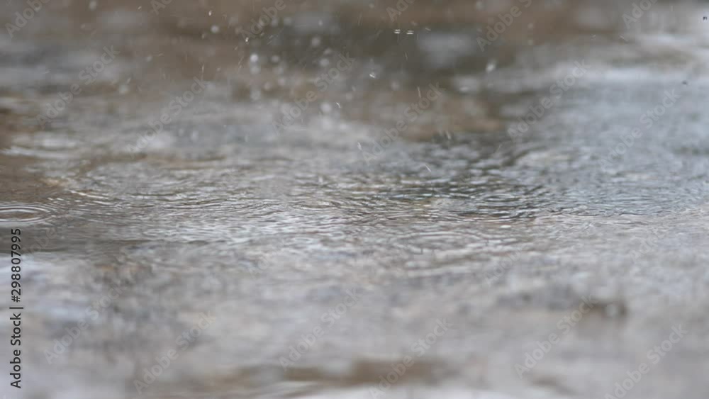 Rain drops on cement during the rainy season Rain drops on cement during the rainy season