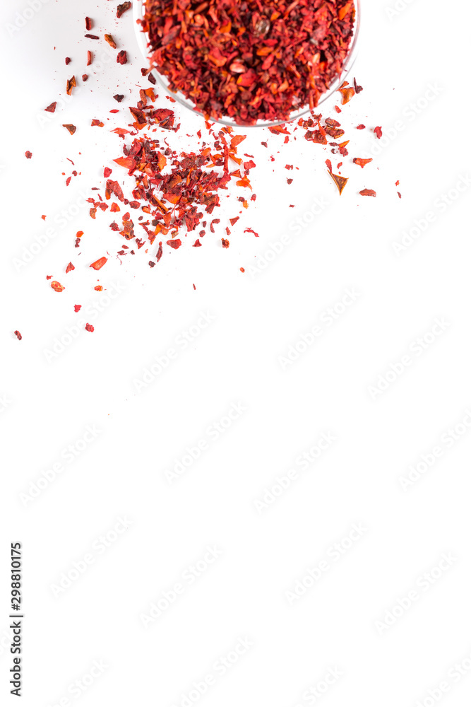 Crushed paprika in a glass bowl on a white background. Copy space concept.