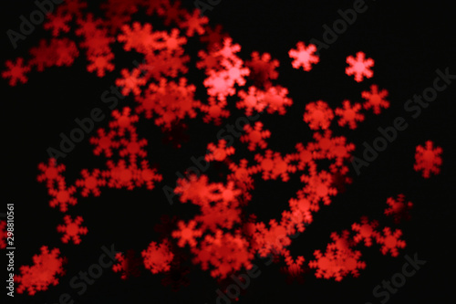 red snowflake glitter sparkle isolated on black background