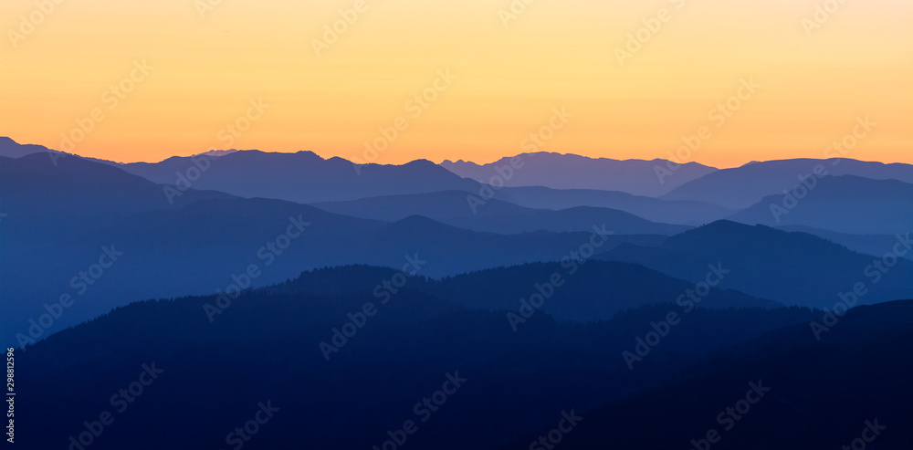 Mountain Silhouette toward alps and dolomites from the Mount Pizzoc (Veneto, Italy) top at sunset in autumn