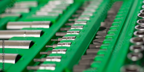 A lot of different tools in the green box. Tools for home workers, factory workers, auto mechanics and other works.