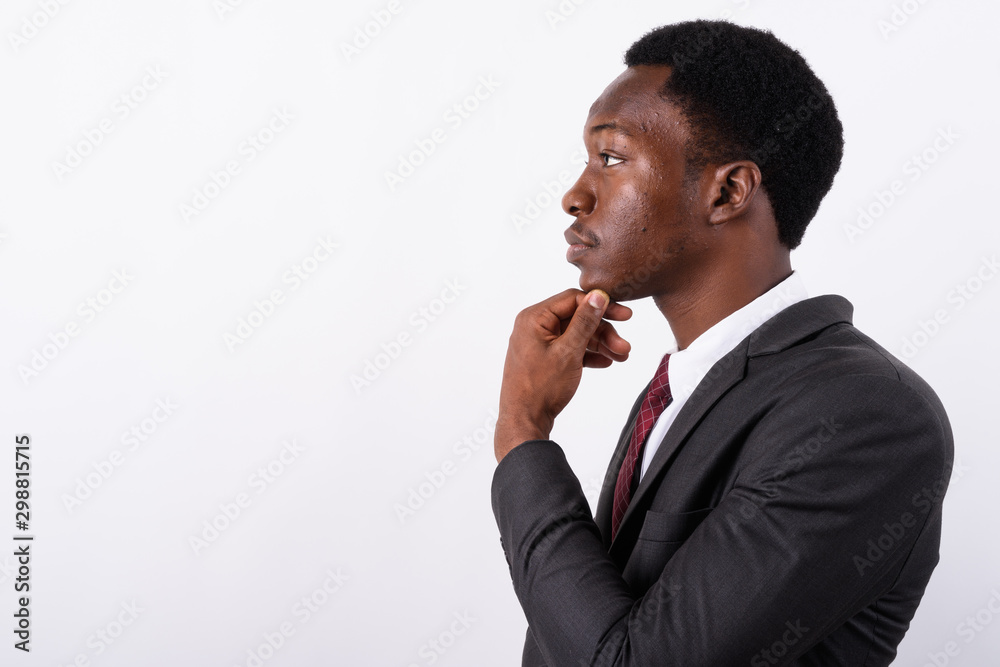 Young handsome African businessman wearing suit against white ba Young handsome African businessman wearing suit against white ba