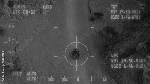 Military Drone tracking an Armed terrorist patrol Vehicle with, Night vision with dynamic tracking crosshair.