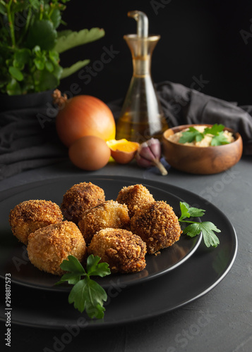 Homemade croquettes on dark wooden background - image