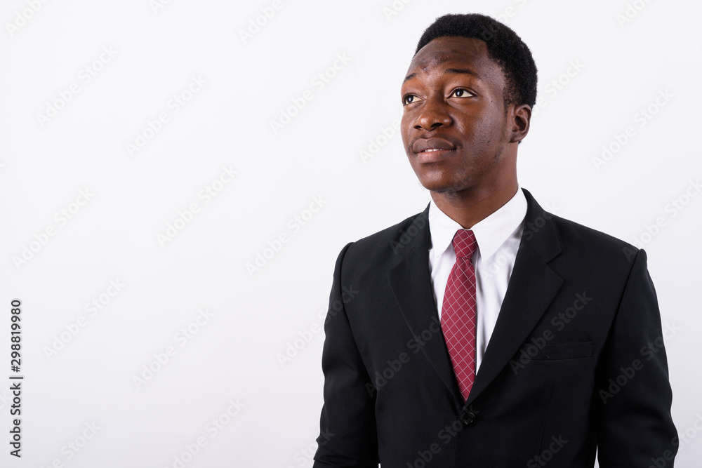 Young handsome African businessman wearing suit against white ba Young handsome African businessman wearing suit against white ba