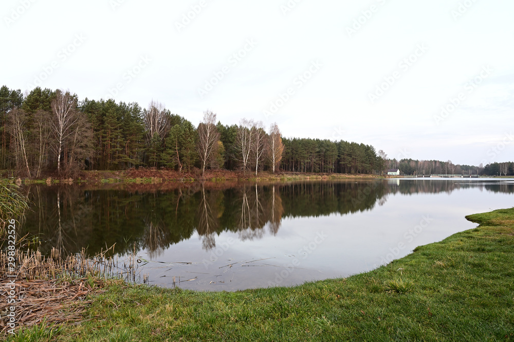 Photo of the river, water pier. Autumn park on the shore. Image of nature, forest, landscape. Photo of the river, water pier. Autumn park on the shore. Image of nature, forest, landscape.