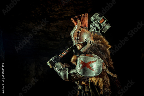 Canvas Print Attack of a powerful knight in the armor with the hammer