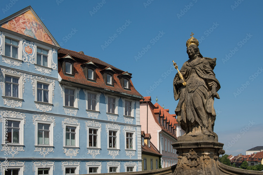 Bamberg, Germany - July 15, 2019; Statue of Queen Kunigunda on the Alte Rathaus bridge in Bamberg on a blue sky on a sunny day