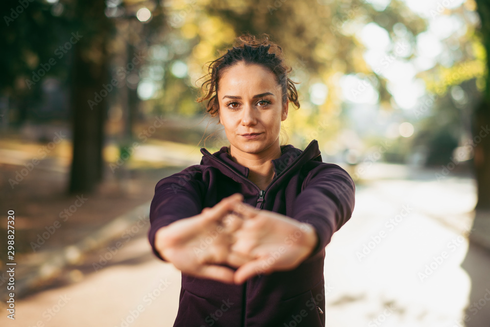 Portrait of sportswoman warming herself up for training. Beautiful woman in sportswear outdoors working out. Portrait of sportswoman warming herself up for training. Beautiful woman in sportswear outdoors working out.