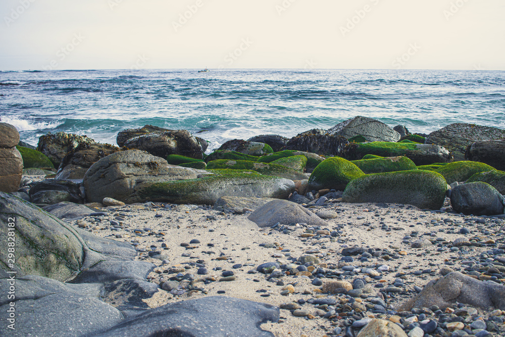 seashore with rocks and sand with pebbles seashore with rocks and sand with pebbles