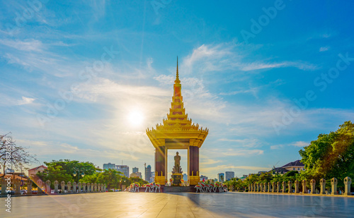 PHNOM PENH, CAMBODIA - October 16,2019 : A Statue of King Father Norodom Sihanouk with blue and yellow sky in evening sunset background at central Phnom Penh, Capital of Cambodia.
