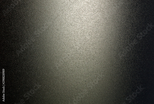 Ground glass texture in black color with light.