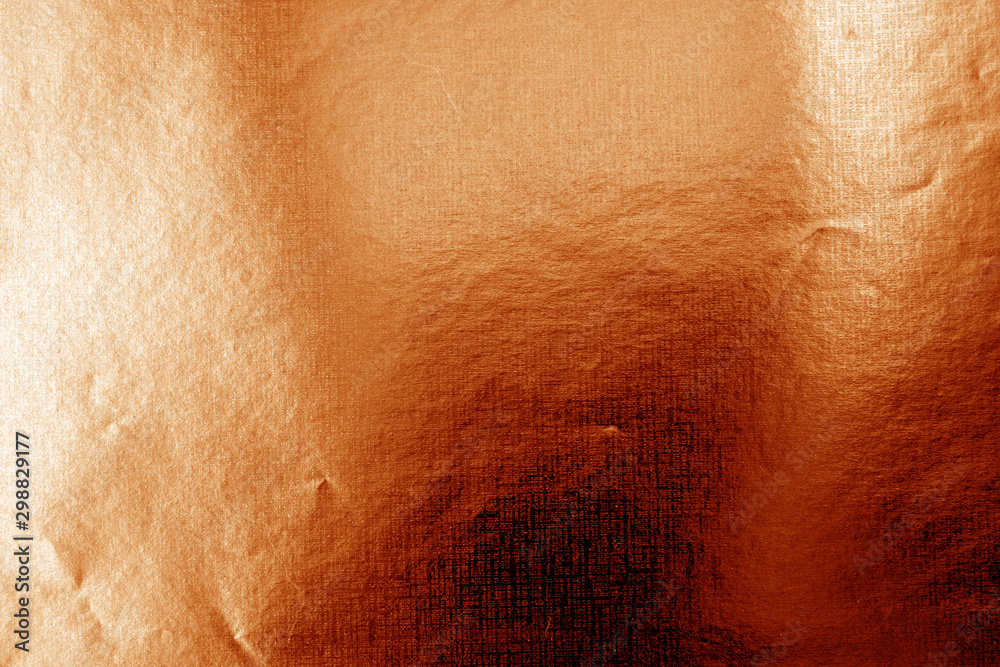 Metalized plasrtic wrap texture with crumples in orange color. Metalized plasrtic wrap texture with crumples in orange color.