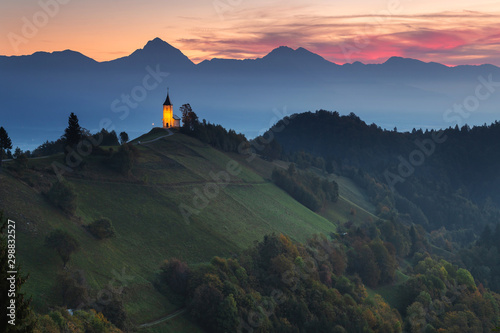 Autumn landscape of a beautiful church on the top of a hill, in Slovenia photo