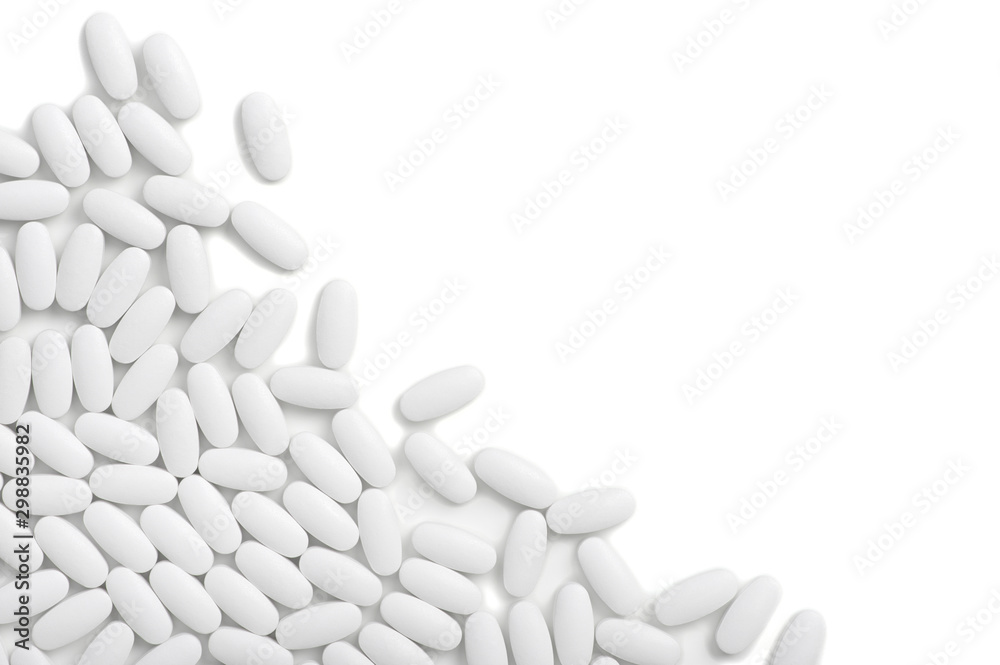 White pills (tablets) background. Top view