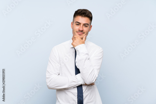 Handsome businessman over isolated blue background laughing