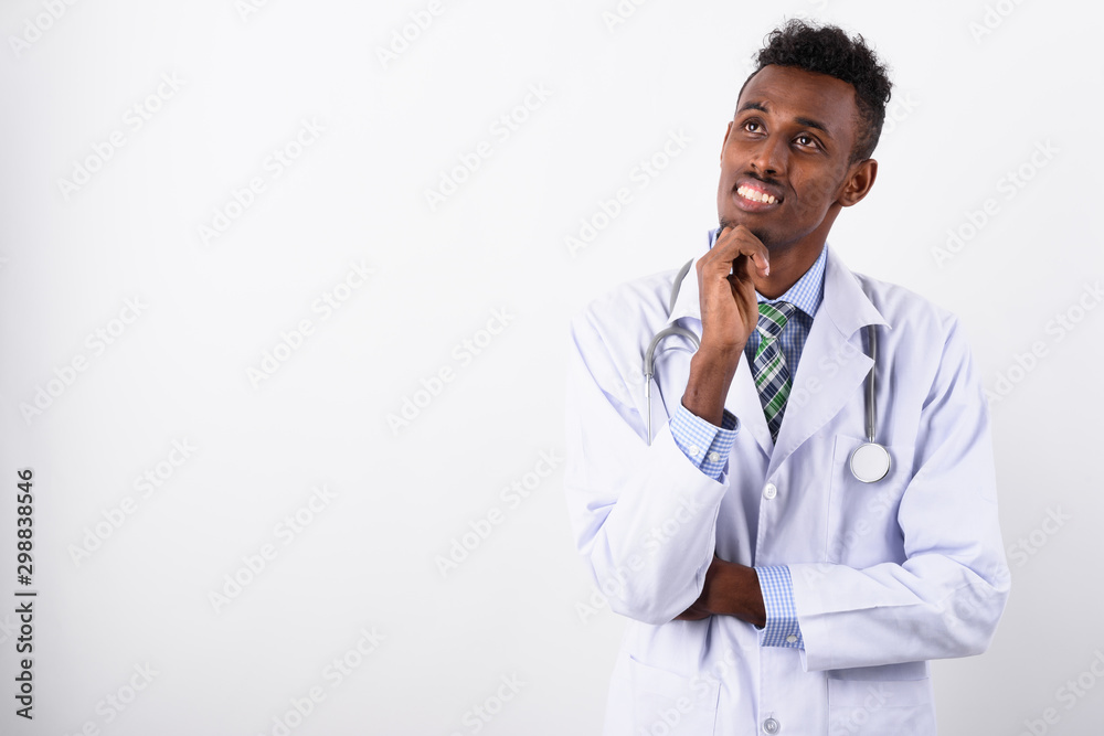 Young bearded African man doctor against white background Young bearded African man doctor against white background