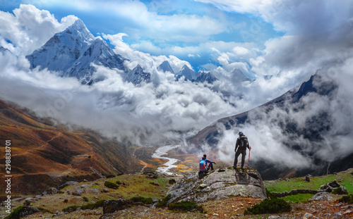 Canvas-taulu Active hikers hiking, enjoying the view, looking at Himalaya mountains landscape