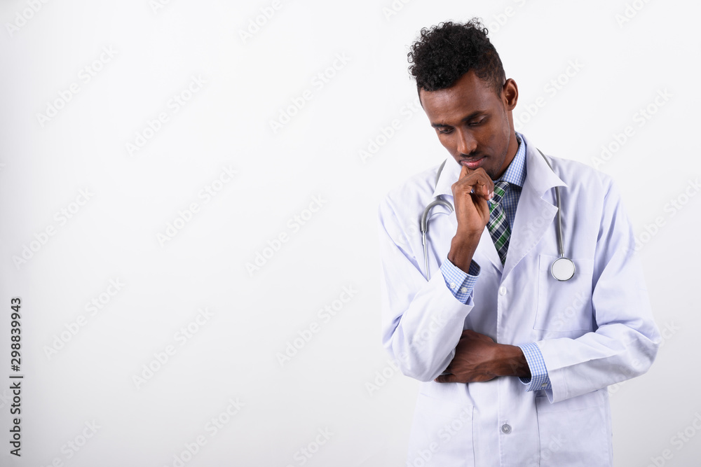 Young bearded African man doctor against white background Young bearded African man doctor against white background