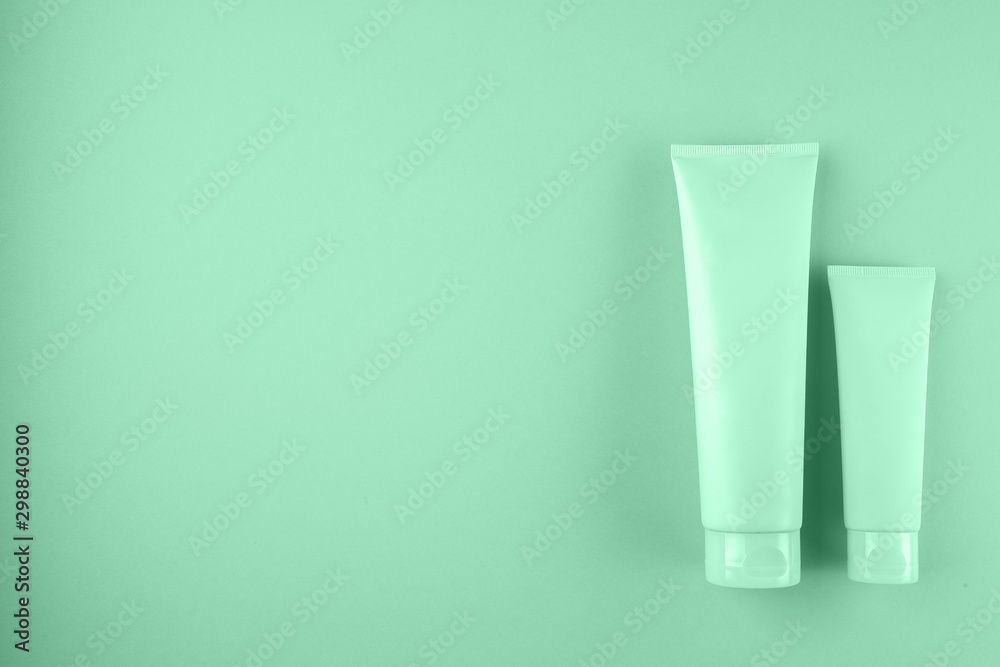 Two cosmetic tubes package on pastel pink background Two cosmetic tubes package on pastel pink background