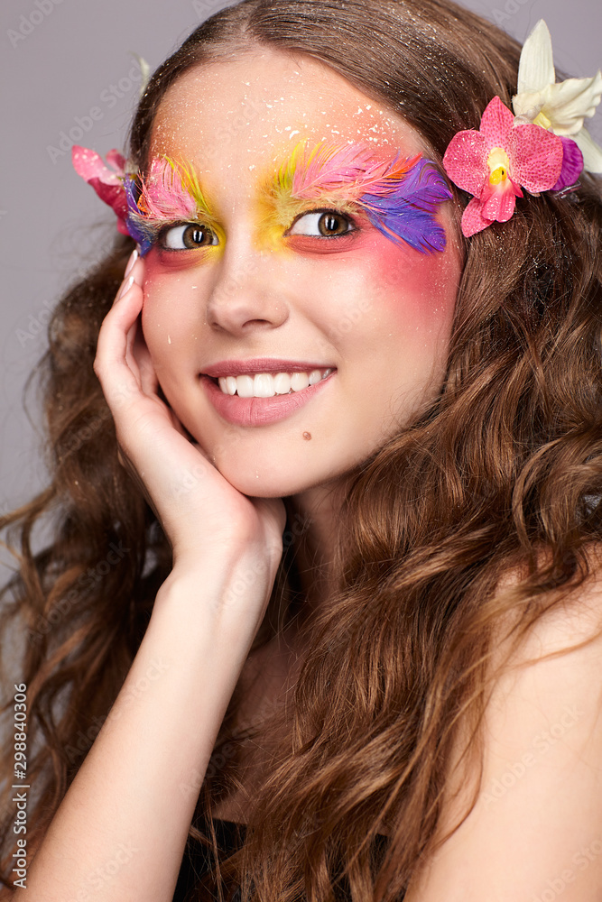 Naklejka premium Female with hand near face and fashion feather eyelashes make-up