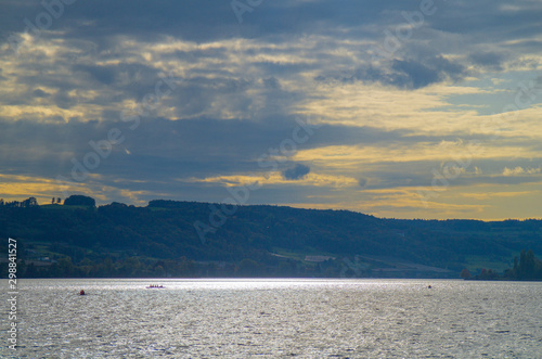 Sport rower on Lake Constance on a beautiful afternoon at the beginning of autumn in the back light. © Kai