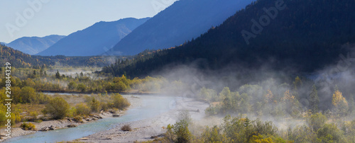 Foggy trees at the river in the Isar Valley, at Vorderriss with parts of the Pfetter Kopf, the hazy Grasberg and Bruensteck Mountains, Upper Bavaria