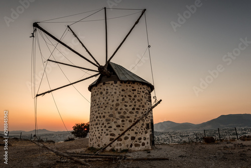 Ancient old windmill at sunset on the hill in the city of Bodrum in Turkey