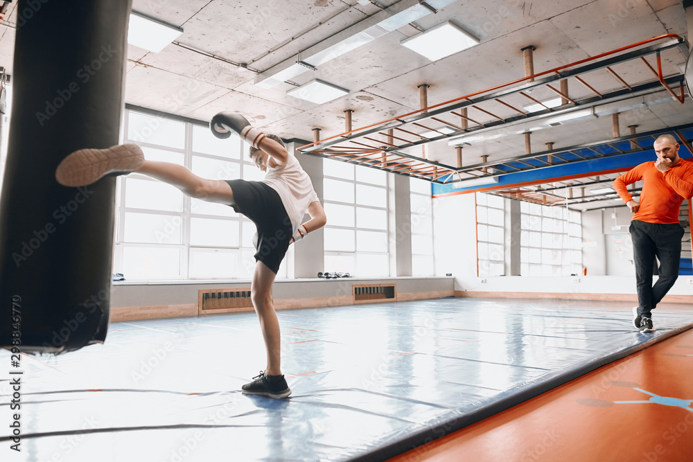 professional experienced coach controlling the boy's training, full length photo professional experienced coach controlling the boy's training, full length photo