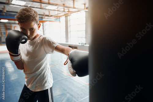 agressive angry boy is good at kickboxing, close up photo. motivation concept