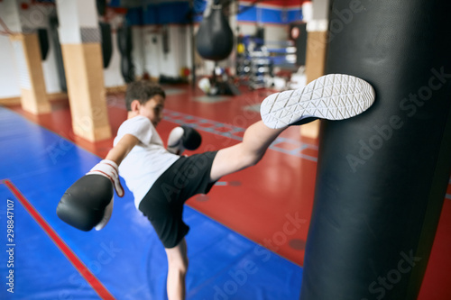 young boy exercising at gym , preparing for competition, close up back view photo. photo