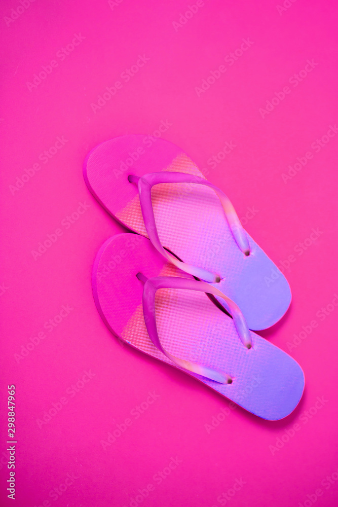 Beach flip flop on yellow background
