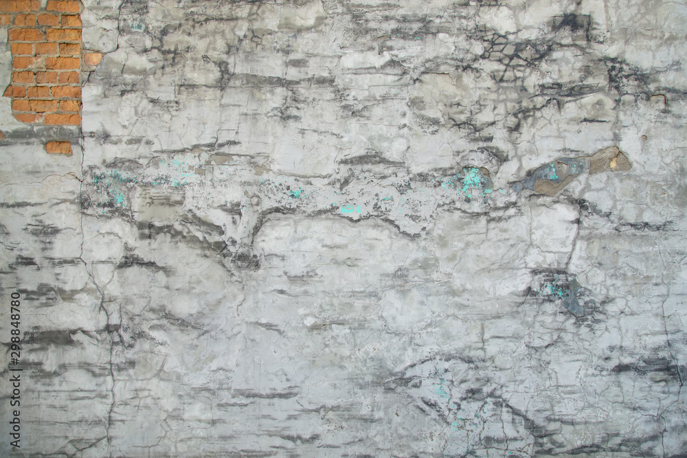Texture of gray old plastered wall with cracks. Horizontal image.