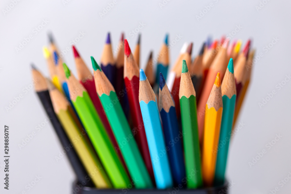 Bunch of random colored pencils, close up macro. White background Bunch of random colored pencils, close up macro. White background