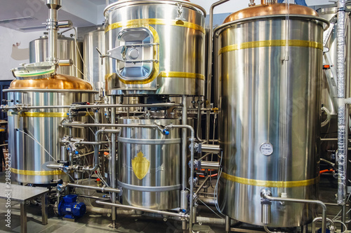 Stainless steel brewing tanks and equipment, iron reservoirs and pipes in modern beer factory