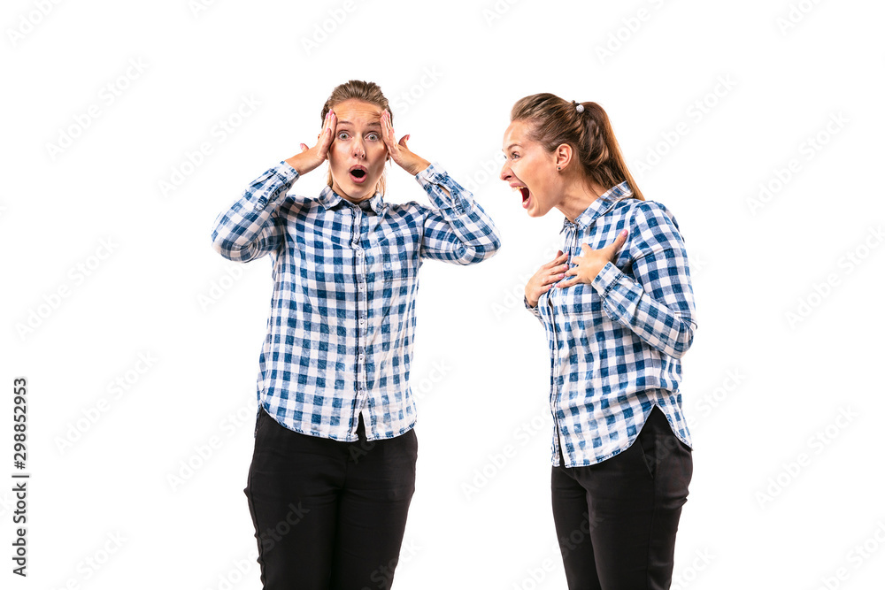 Young handsome woman arguing with herself on white studio background. Concept of human emotions, expression, mental issues, internal conflict, split personality. Half-length portrait. Negative space. Young handsome woman arguing with herself on white studio background. Concept of human emotions, expression, mental issues, internal conflict, split personality. Half-length portrait. Negative space.