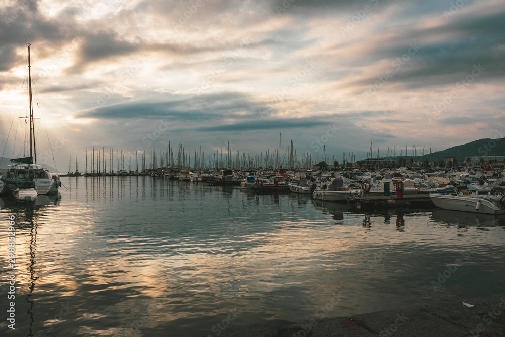 Fototapeta premium sunrise at a pier with boats