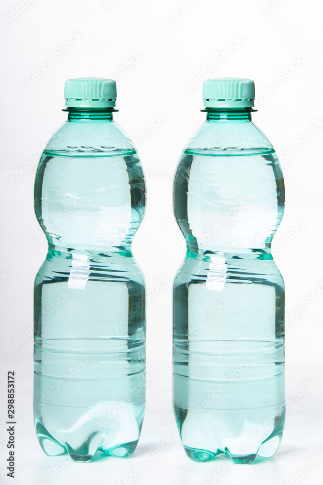 Two plastic bottles with water on a white background Two plastic bottles with water on a white background