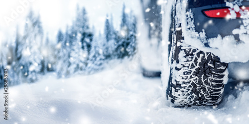 Winter tire banner or panorama detail in white snow. Car tires in snowy background..