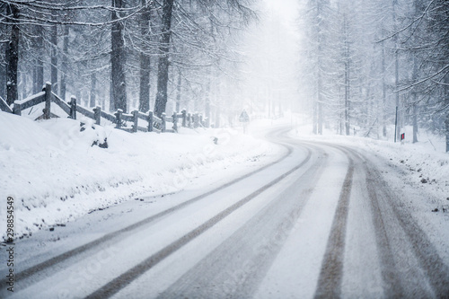 Winter snowy or calamity road in forest mountains. Beautiful snow road.