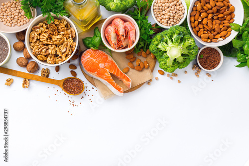 Food sources of omega 3 and omega 6 on white background top view. Foods high in fatty acids including vegetables, seafood, nut and seeds photo