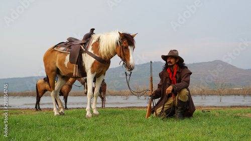Fototapeta Naklejka Na Ścianę i Meble -  cowboy and horse at first light,mountain, river and lifestyle with natural light background	