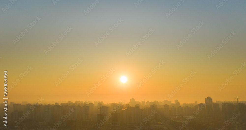 Fototapeta premium Sunrise over the metropolis Beautiful cityscape early in the morning. Aerial drone shot