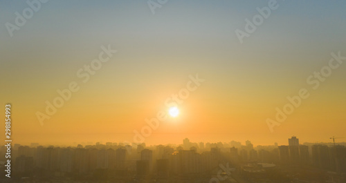 Sunrise over the metropolis Beautiful cityscape early in the morning. Aerial drone shot