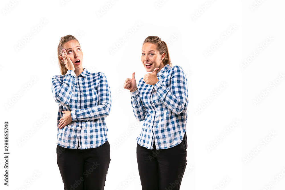 Young handsome woman arguing with herself on white studio background. Concept of human emotions, expression, mental issues, internal conflict, split personality. Half-length portrait. Negative space.