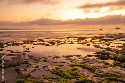 Seascape. Golden hour of sunset at the beach. Ocean low tide. Horizontal background banner. Nyang Nyang beach, Bali, Indonesia.